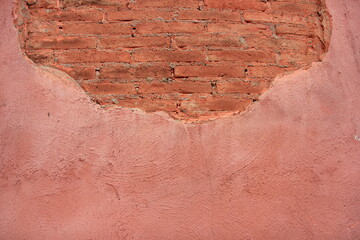 Old brick wall, old texture of pink stone blocks and wall cement.