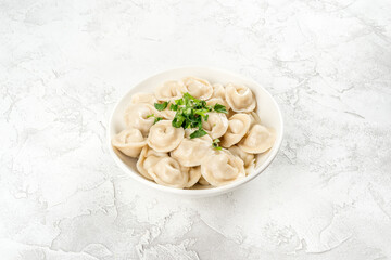 Boiled dumplings in a white, round plate