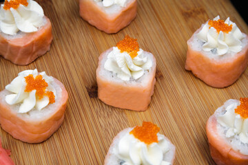 Obraz na płótnie Canvas Smoked salmon rolls with cream cheese and wasabi.