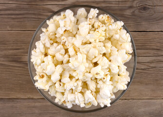 Popcorn in a bowl on a wooden table