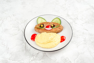 Fried cutlet with crushed potatoes in a white plate
