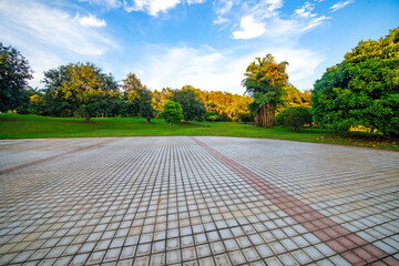 Outdoor park square's brick walkway at sunrise and sunset.