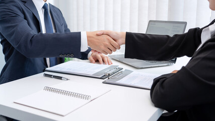 two business people shaking hands of Candidate asian businesswoman after successful negotiations or interview, career and placement concept.