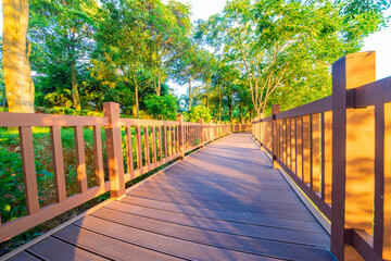 Outdoor park square with brick walkways and wooden paths at sunrise and sunset.