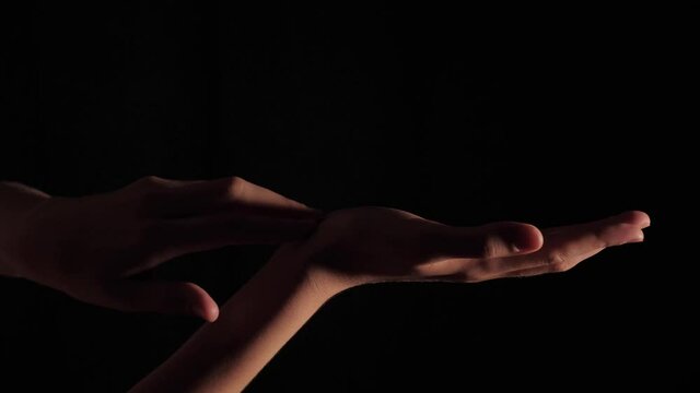Close-up of female hands of a pianist moving chaotically on a black isolated background. Foot 3840x2160 (4K) shot in real time with artificial professional lighting