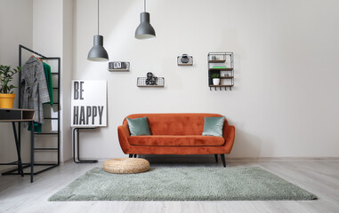 Stylish interior of living room with sofa and carpet