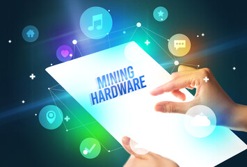 Holding futuristic tablet with MINING HARDWARE inscription, new technology concept