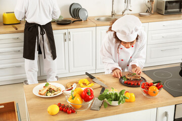 African-American chefs cooking in kitchen