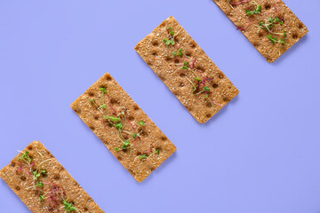 Rye crispbreads with sprouts on color background