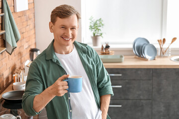 Handsome man drinking tea at home