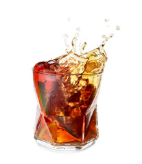 Glass of tasty Cuba Libre cocktail with splash on white background