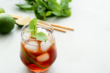 Glass of tasty Cuba Libre cocktail on table