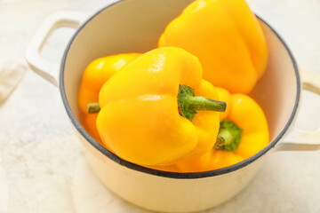 Yellow bell pepper in saucepan on table
