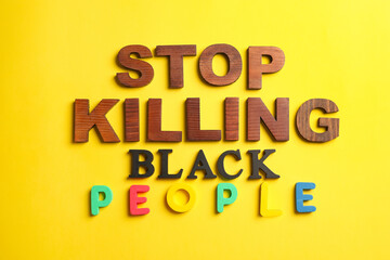 Text STOP KILLING BLACK PEOPLE on color background