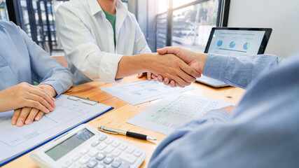 young Asian couple feeling happy and pleasant after received advice discussion about financial planning for investment at the meeting with financial advisor staff at home