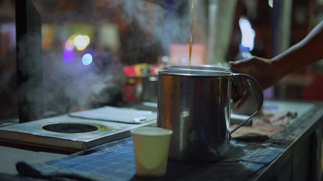 Acehnese barista manually pouring coffee in traditional method, also known as Kupi Sareng Aceh
