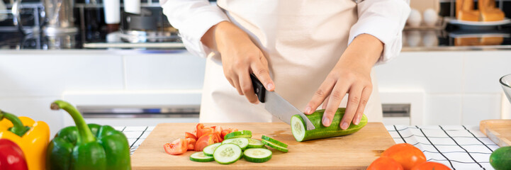 Asian woman is preparing healthy food vegetable salad at light kitchen Cooking At Home and healthy food concept
