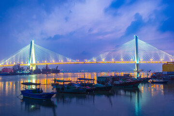 Fototapeta na wymiar A bridge crosses the sea at night in hainan, China.
