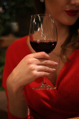 young beautiful girl drinks wine in a glass