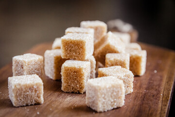 Brown cane sugar cubes on a cutting board