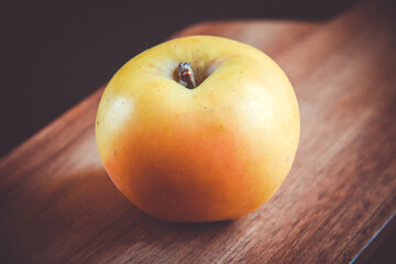 Apple on wooden cutting board