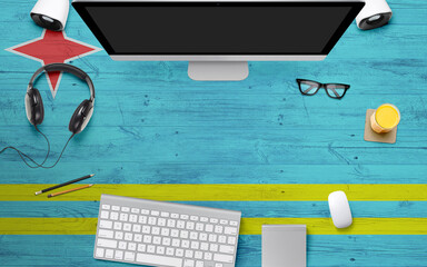 Aruba flag background with headphone,computer keyboard and mouse on national office desk table.Top...