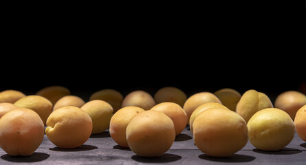 Ripe apricots on a wooden background