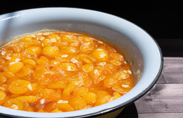 Apricot jam on a wooden background