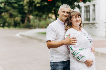 Beautiful young pregnant couple in nature