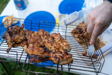 Pieces of fried chicken on a barbecue