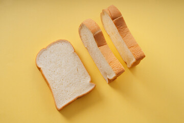 Home made organic sliced bread over yellow background.