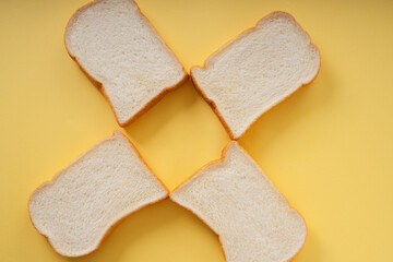 Top view - Home made organic sliced bread over yellow background.