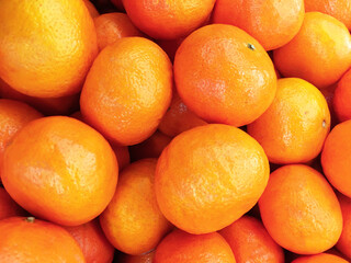Healthy fruits, orange fruits background many orange fruits - orange fruit background in a supermarket super store