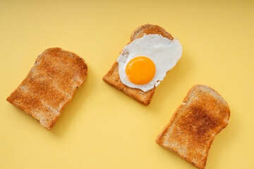 Three home made organic sliced bread grill with fried egg on top.