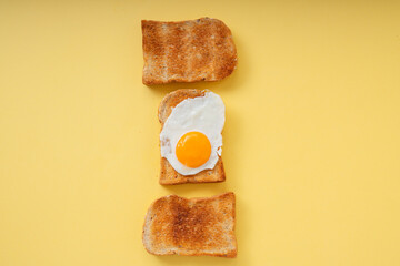 Three home made organic sliced bread grill with fried egg on top.