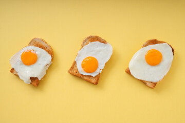 Three home made organic sliced bread grill with fried egg on top.