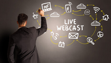 businessman drawing social media icons with LIVE WEBCAST inscription, new media concept