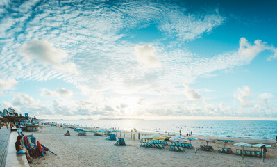 People having rest on beach in Vungtau in sunset light. The Vungtau city is popular among Ho chi minh city people as sea resort.