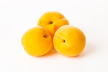 Three tasty isolated peaches on a white background