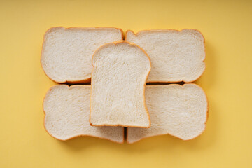 Top view - Home made organic sliced bread over yellow background.