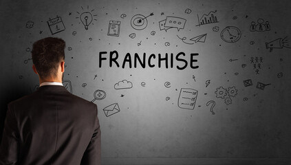 businessman drawing a creative idea sketch with FRANCHISE inscription, business strategy concept