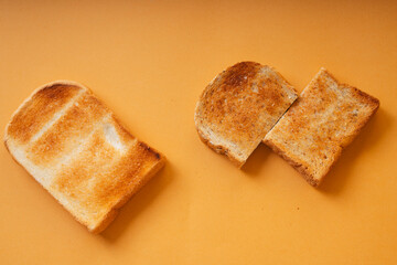 Top view - Grill sliced bread over orange background.