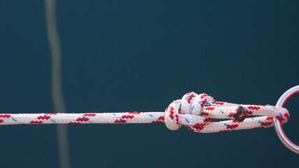 a strong rope with a strong marine knot holyard hitch tied to a metal ring