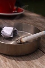 cigarettes burned in an ashtray during the day