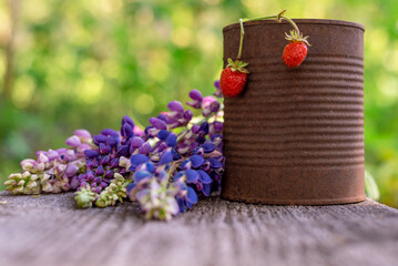 Strawberries and flowers on a wooden table