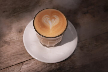 coffe latte cup on a wood table.