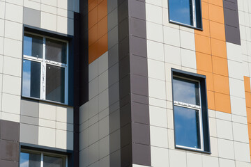 facade of a modern building on a bright Sunny day, siding and Windows, beautiful exterior of the new building
