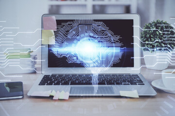 Double exposure of table with computer and brain hologram. Data innovation concept.