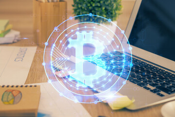 Multi exposure of blockchain theme hologram and table with computer background. Concept of bitcoin...