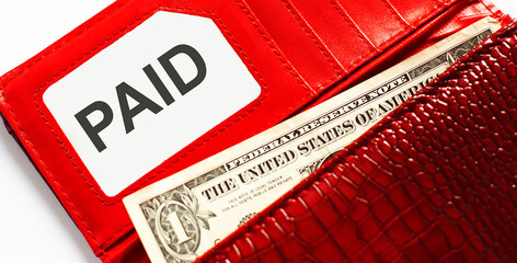 Words text PAID on business card, and red leather wallet. Financial,business concept